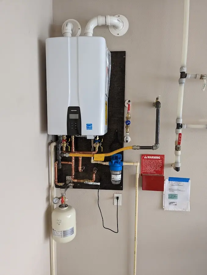 Professional plumber installing copper piping in a Mohawk home